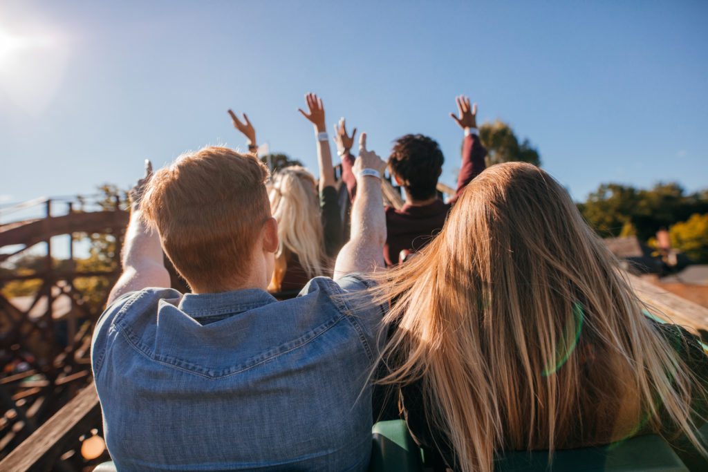 People Enjoying At Amusement Park In Roller Coaster in California