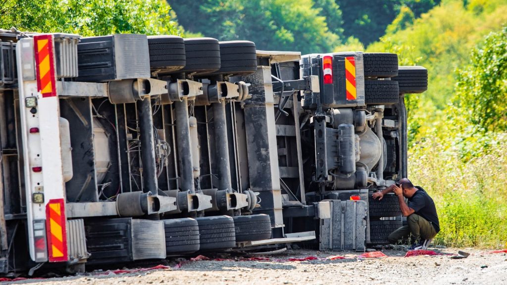 truck driver inspecting the vehicle after a truck accident
