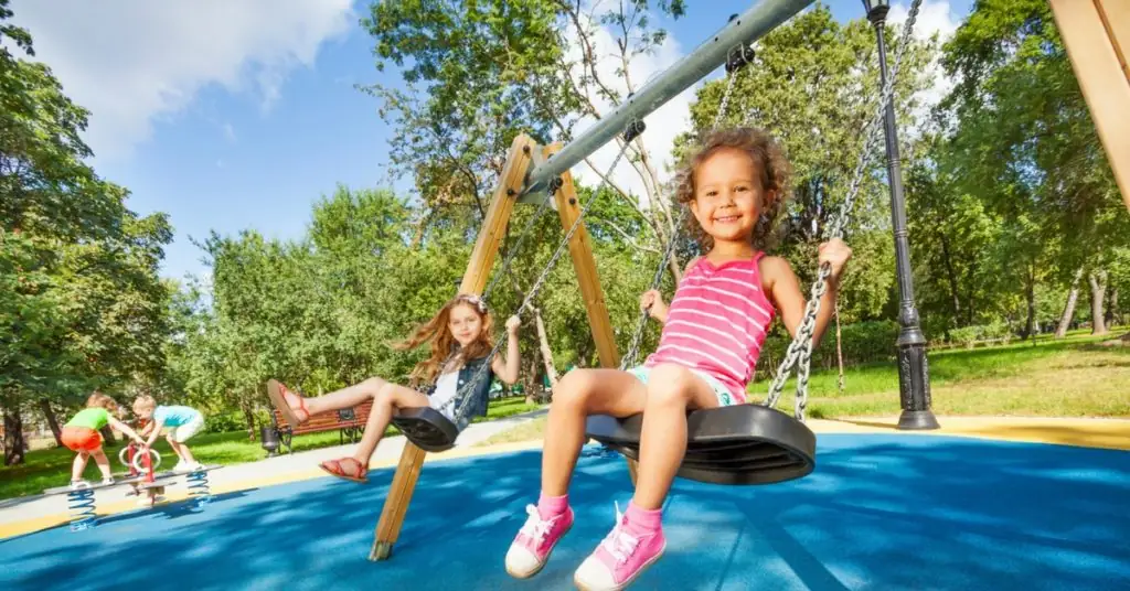 2 girls on a swingset