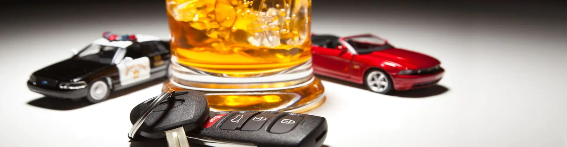 drink with keys left nearby to signal the dangers of drunk driving
